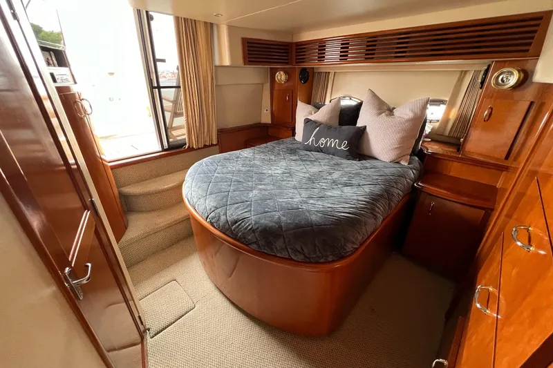 Slide: The Image of Luxurious bedroom interior of 2003 Carver 444 Cockpit Motor Yacht with cozy bedding. - 57