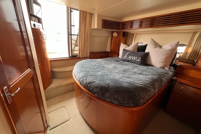 Slide: The Image of Luxurious bedroom interior of 2003 Carver 444 Cockpit Motor Yacht with cozy bedding. - 58