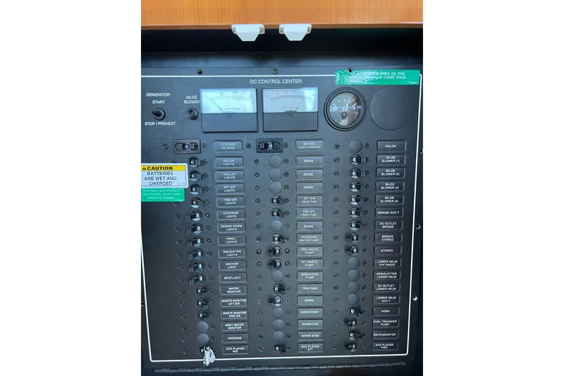 Slide: The Image of Control panel of 2003 Carver 444 Cockpit Motor Yacht with various switches and gauges. - 65