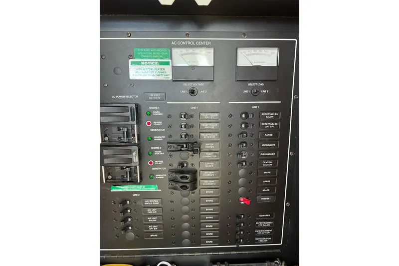 Slide: The Image of Electrical control panel of a 2003 Carver 444 Cockpit Motor Yacht, featuring various switches and meters. - 66