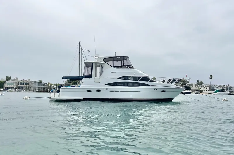 Slide: The Image of 2003 Carver 444 Cockpit Motor Yacht on calm water, overcast sky background. - 7