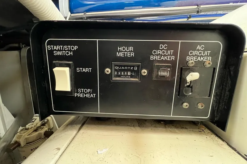 Slide: The Image of Control panel of 2003 Carver 444 Cockpit Motor Yacht with hour meter and circuit breakers. - 76