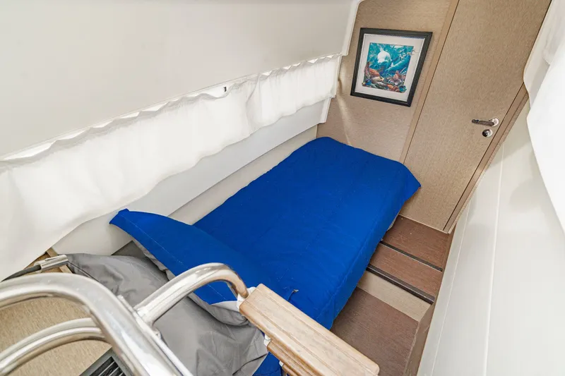 Slide: The Image of Interior of a 2018 Prestige 560 yacht with single bed and artwork. - 11