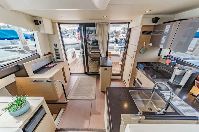 Slide: The Image of Interior of a 2018 Prestige 560 yacht, featuring modern kitchen and living area. - 16