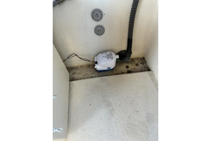 Slide: The Image of 1999 Rosborough 246 boat interior with bilge pump and wiring. - 13