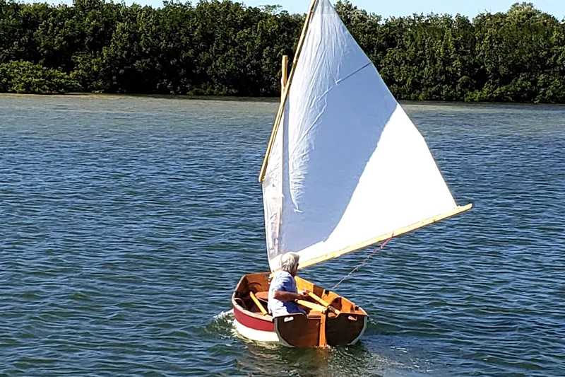 Slide: The Image of Small sailboat on water, Rosborough 246 model, 1999, with lush green shoreline. - 15