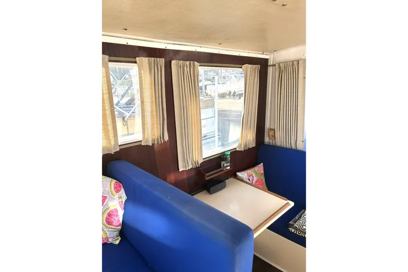 Slide: The Image of Interior of 1999 Rosborough 246 boat with blue seating and decorative pillows. - 4