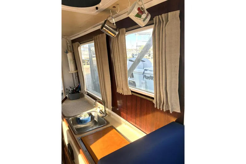 Slide: The Image of Interior of 1999 Rosborough 246 boat with sink, window, and curtains. - 5