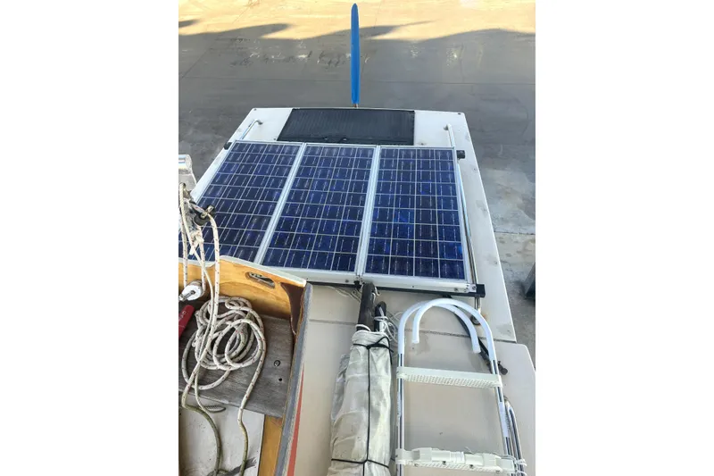 Slide: The Image of 1999 Rosborough 246 boat with solar panels and nautical equipment on deck. - 7