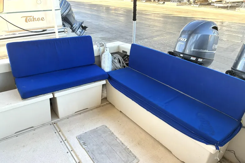 Slide: The Image of 1999 Rosborough 246 boat interior with blue cushioned seating and Yamaha outboard motors. - 9