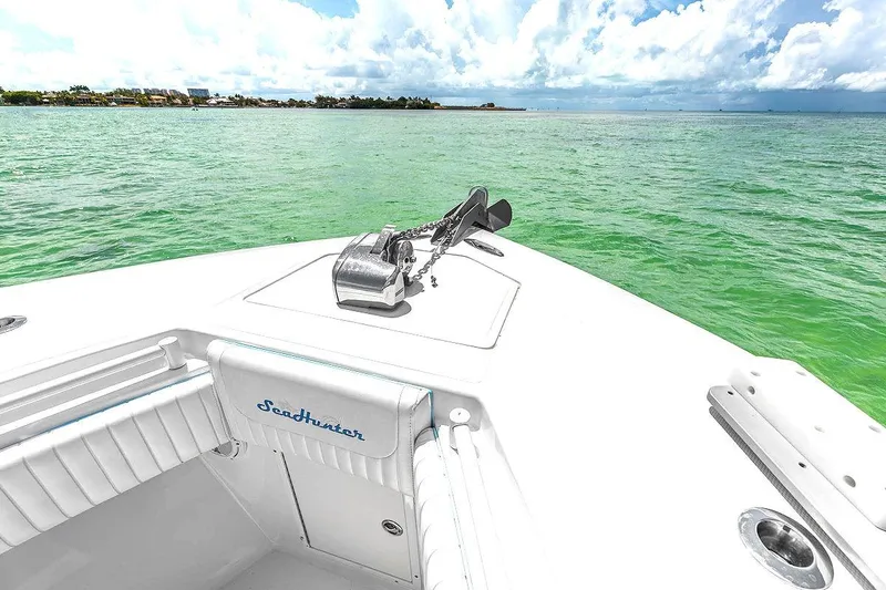 Slide: The Image of 2017 SeaHunter 39 boat on clear green water under a partly cloudy sky. - 10