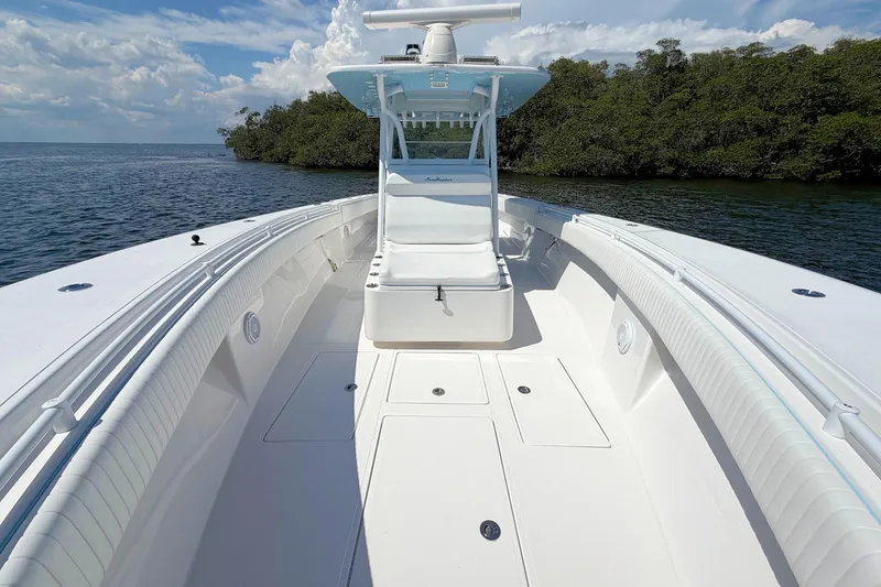 Slide: The Image of 2017 SeaHunter 39 boat with spacious deck, white seating, and clear blue sky. - 17