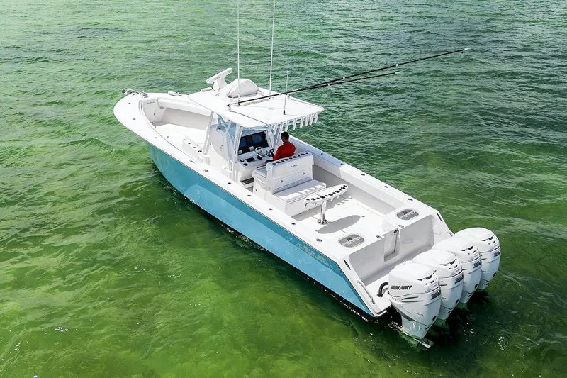 Slide: The Image of 2017 SeaHunter 39 boat with four Mercury engines on clear green water. - 3