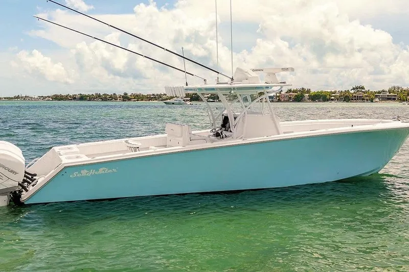 Slide: The Image of 2017 SeaHunter 39 boat on clear water, featuring a sleek design and fishing rods. - 4