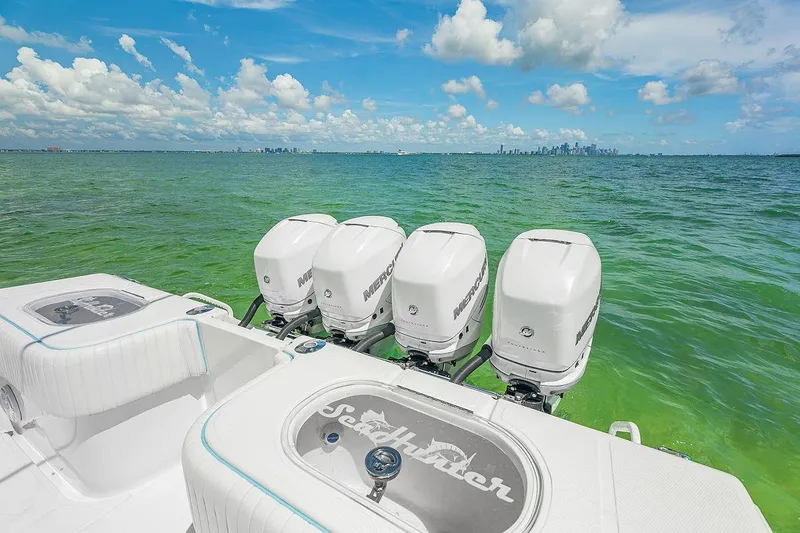 Slide: The Image of 2017 SeaHunter 39 boat with four Mercury engines on a clear, sunny day. - 6