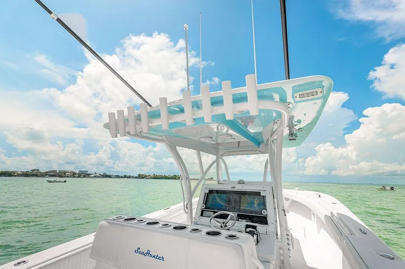 Slide: The Image of 2017 SeaHunter 39 boat on water, featuring helm and rod holders under a clear blue sky. - 8