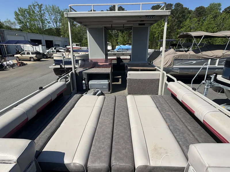 Slide: The Image of 1990 Sun Tracker Party Hut 28 pontoon boat with outdoor seating. - 14