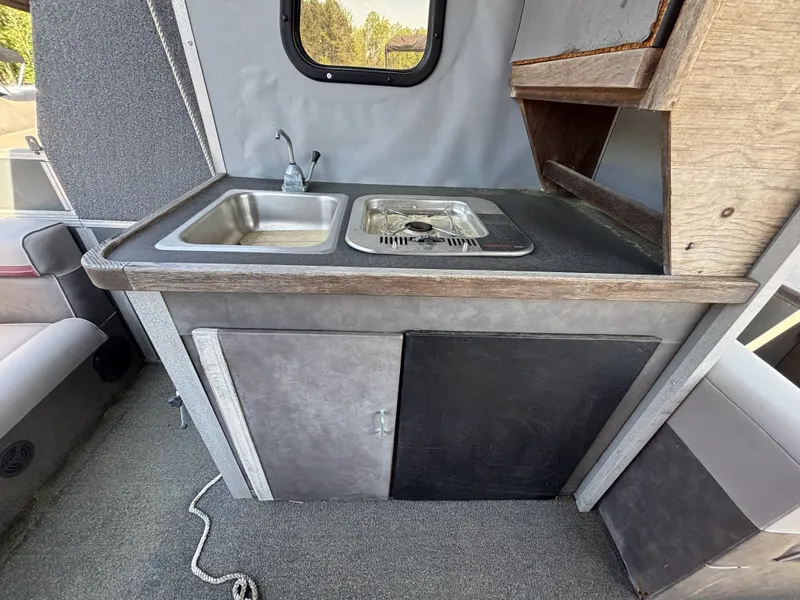 Slide: The Image of Kitchen area in a 1990 Sun Tracker Party Hut 28 boat. - 20