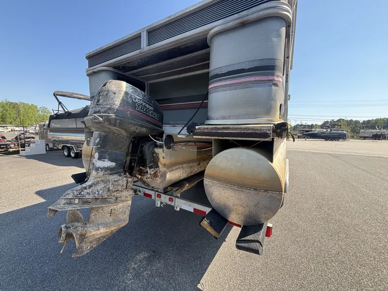 Slide: The Image of 1990 Sun Tracker Party Hut 28 with Johnson motor on trailer. - 3