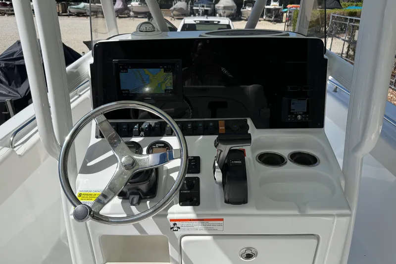 Slide: The Image of 2020 Sea Hunt Ultra 225 boat dashboard with steering wheel and navigation system. - 13