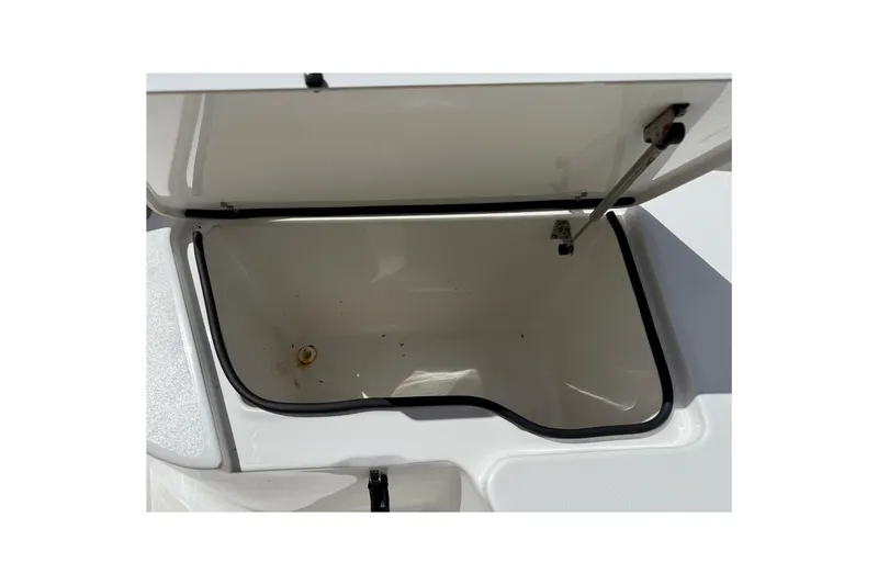Slide: The Image of Open storage compartment on a 2020 Sea Hunt Ultra 225 boat. - 19