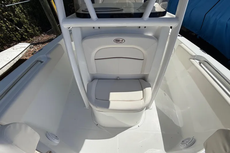 Slide: The Image of 2020 Sea Hunt Ultra 225 boat interior with white seating and console. - 22