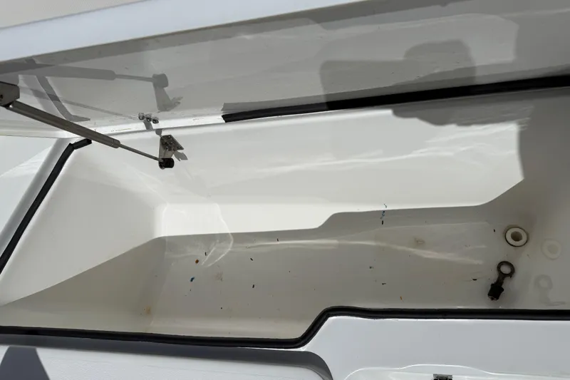 Slide: The Image of Open storage compartment of 2020 Sea Hunt Ultra 225 boat, showing interior details. - 24