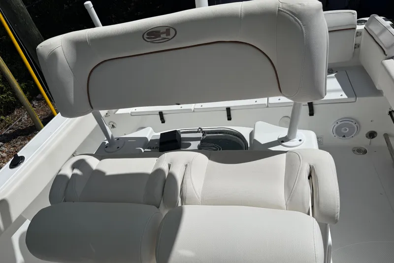 Slide: The Image of 2020 Sea Hunt Ultra 225 boat interior with white cushioned seating. - 26