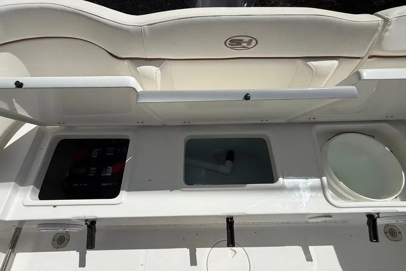 Slide: The Image of 2020 Sea Hunt Ultra 225 boat interior with storage compartments and seating. - 27