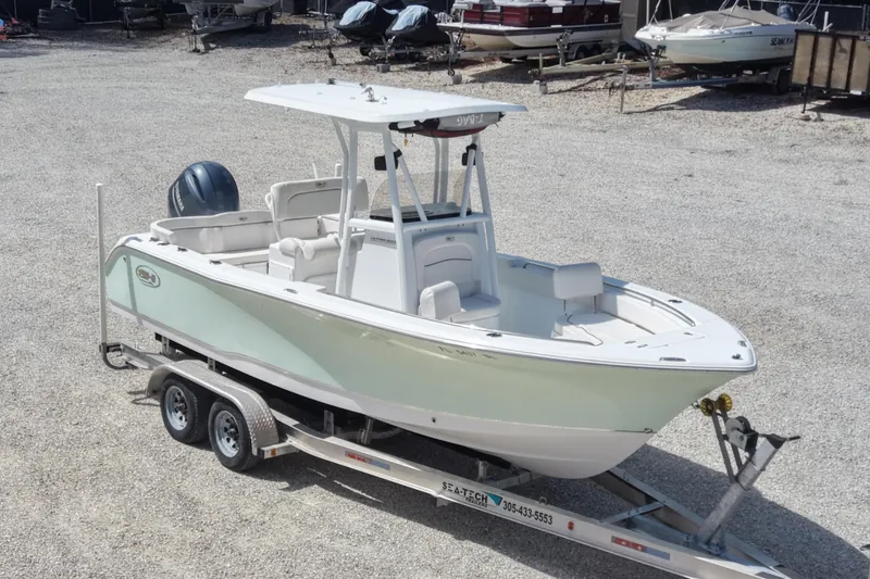Slide: The Image of 2020 Sea Hunt Ultra 225 boat on trailer in a gravel lot. - 3