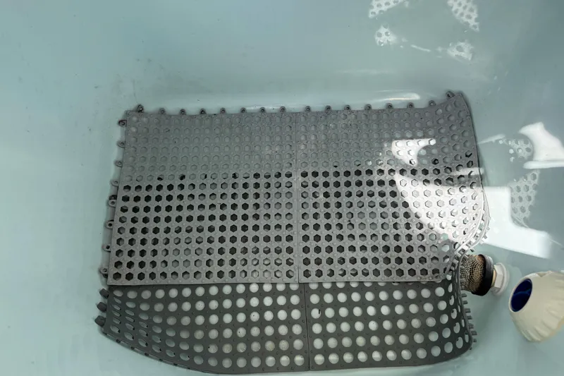 Slide: The Image of Gray perforated mat in a Sea Hunt Ultra 225 boat's storage compartment, 2020 model. - 30