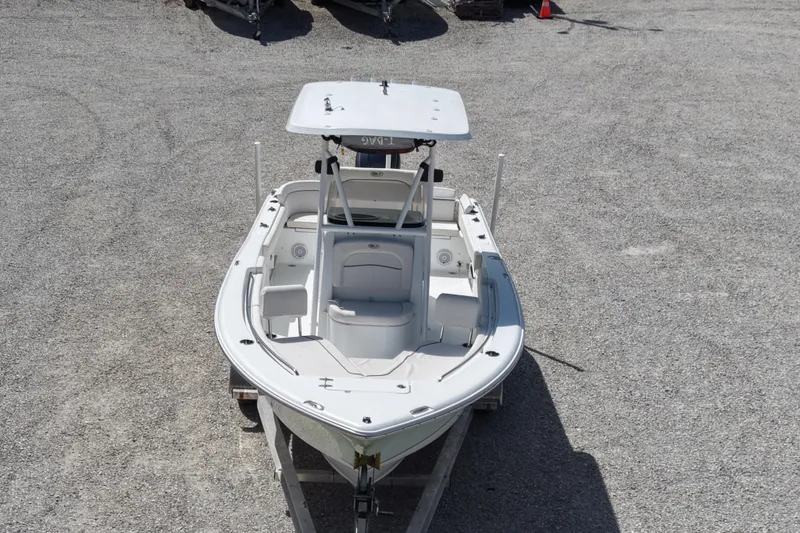 Slide: The Image of 2020 Sea Hunt Ultra 225 boat on trailer, viewed from above, parked on gravel. - 5