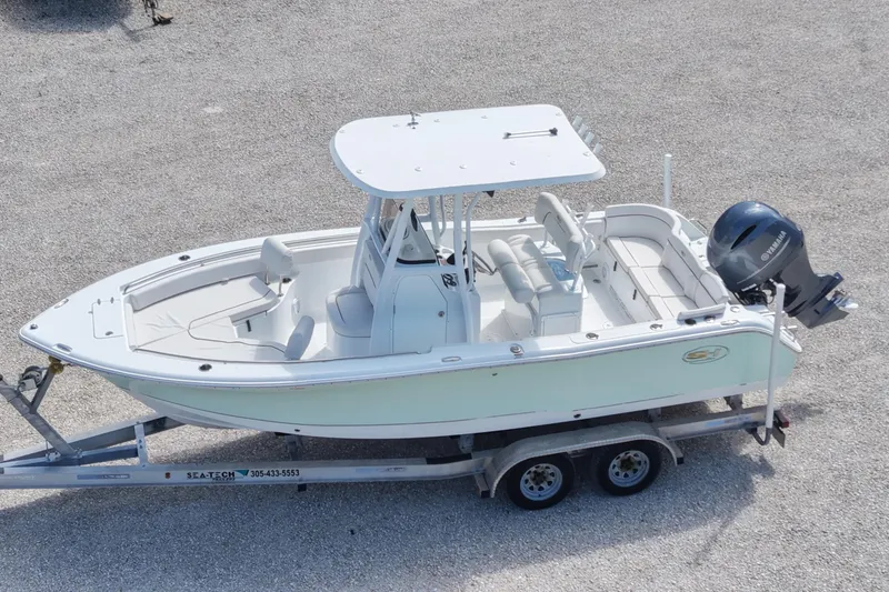 Slide: The Image of 2020 Sea Hunt Ultra 225 boat on trailer, featuring sleek design and Yamaha outboard motor. - 7