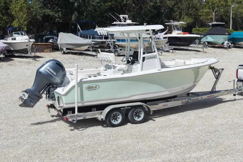 Slide: The Image of 2020 Sea Hunt Ultra 225 boat on trailer with Yamaha outboard motor in a boatyard. - 9