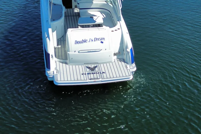 Slide: The Image of 2007 Formula 370 Super Sport boat on water, rear view, named "Double J's Dream". - 10