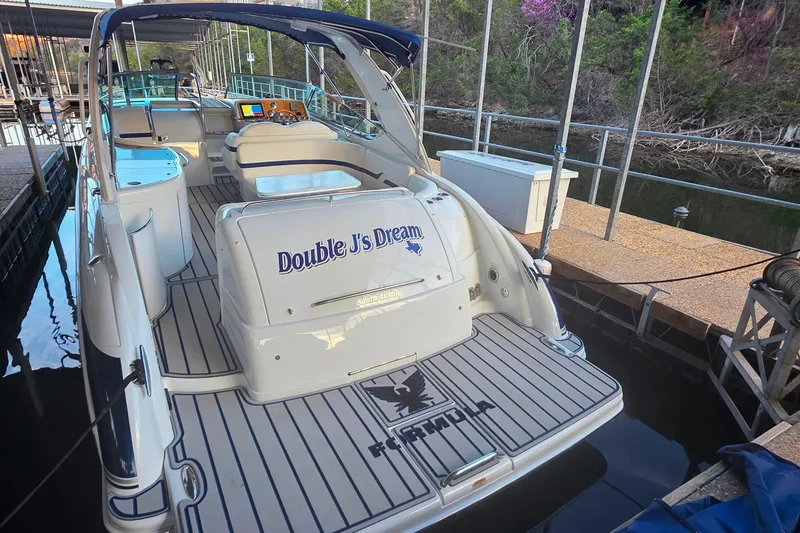 Slide: The Image of 2007 Formula 370 Super Sport boat docked, featuring "Double J's Dream" on the stern. - 11