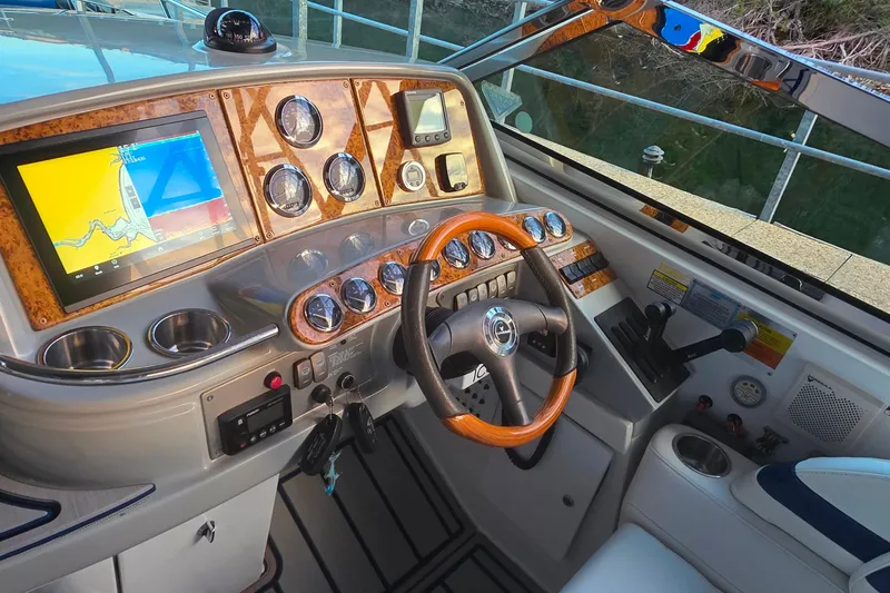 Slide: The Image of 2007 Formula 370 Super Sport boat dashboard with navigation screen and wooden steering wheel. - 18