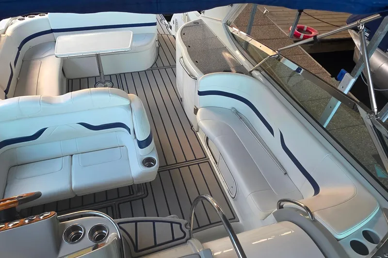 Slide: The Image of 2007 Formula 370 Super Sport boat interior with white seating and table. - 23