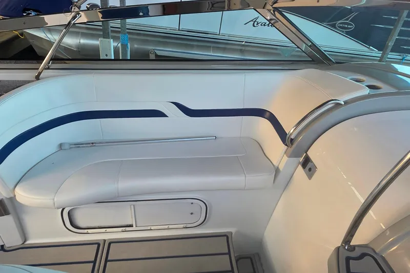 Slide: The Image of 2007 Formula 370 Super Sport boat interior with white seating and blue accents. - 24