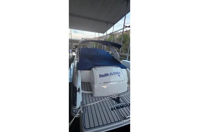 Slide: The Image of 2007 Formula 370 Super Sport boat docked, covered with blue tarp, named "Double J's Dream". - 27