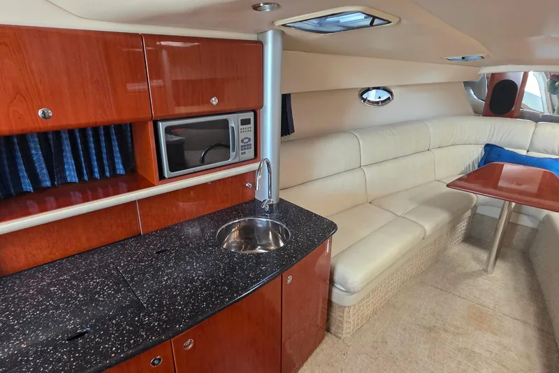 Slide: The Image of 2007 Formula 370 Super Sport yacht interior with kitchenette, seating, and table. - 30