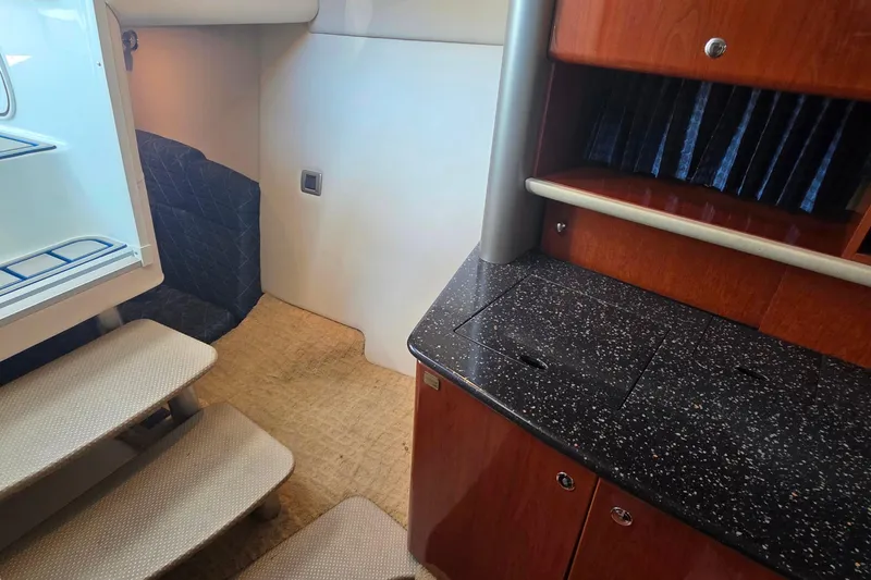 Slide: The Image of 2007 Formula 370 Super Sport interior with stairs, countertop, and wooden cabinetry. - 38