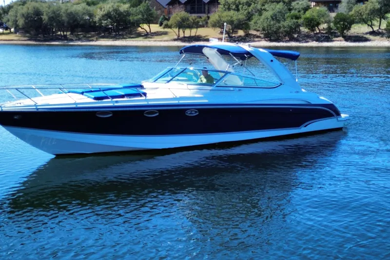 Slide: The Image of 2007 Formula 370 Super Sport boat on a serene lake with trees in the background. - 7