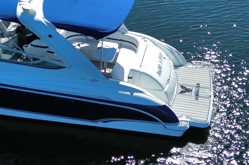 Slide: The Image of 2007 Formula 370 Super Sport boat with blue canopy on sparkling water. - 9