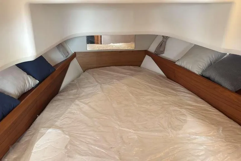 Slide: The Image of Cozy interior cabin of 2021 Nimbus T11 boat with cushions and wooden accents. - 7