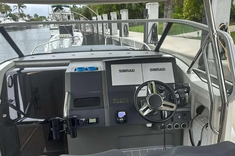 Slide: The Image of Cockpit of 2021 Nimbus T11 boat with Simrad navigation system and steering wheel. - 14
