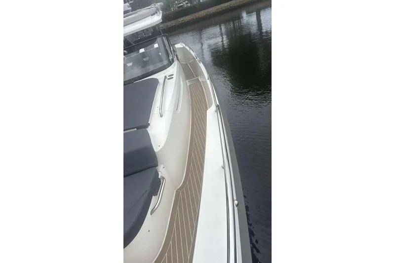 Slide: The Image of 2021 Nimbus T11 boat with sleek deck design on calm water. - 15