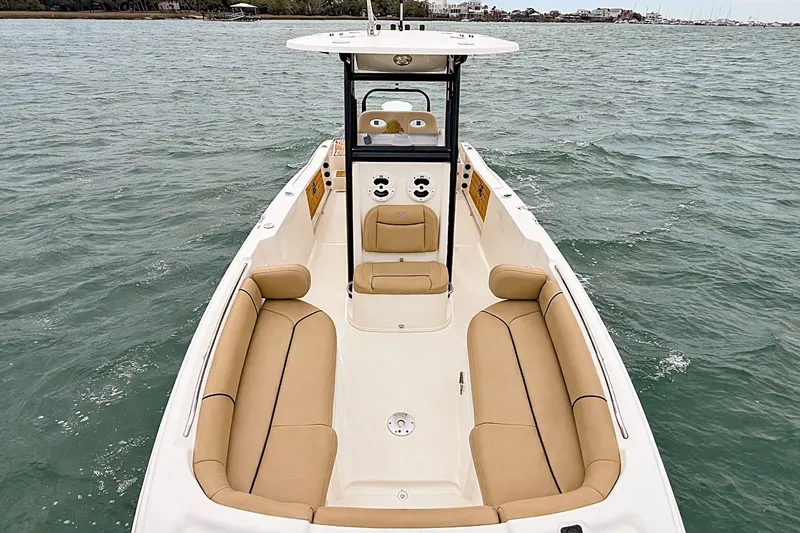 Slide: The Image of 2020 NauticStar 251 Hybrid boat with tan seating on open water. - 12