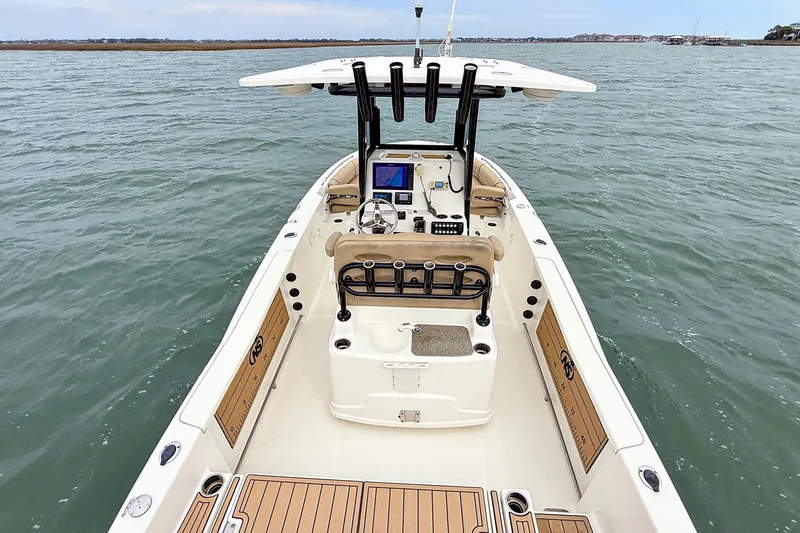 Slide: The Image of 2020 NauticStar 251 Hybrid boat on water, featuring modern helm and spacious deck. - 17