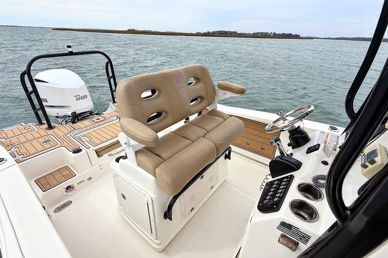 Slide: The Image of 2020 NauticStar 251 Hybrid boat interior with helm and seating on open water. - 19